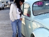 Elvia admires Foster\'s stunning Beetle. Best of both world\'s. Break out the whips and heels please.